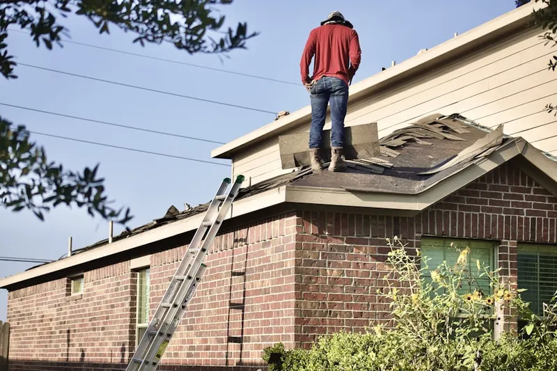 Professional roofer working on a residential roof in Pointville